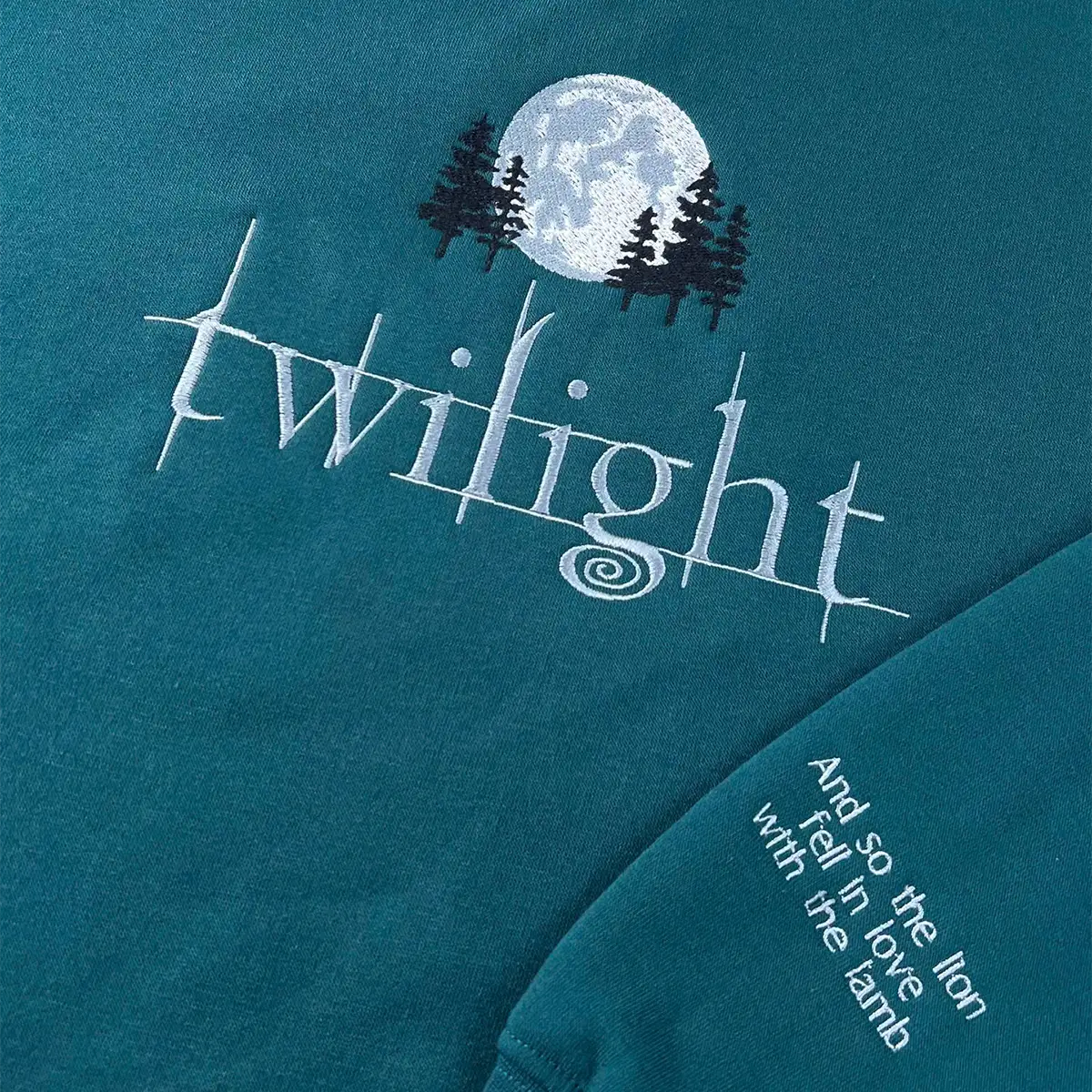 Teal t-shirt with 'Twilight' design featuring a moon and trees on a dark blue background.