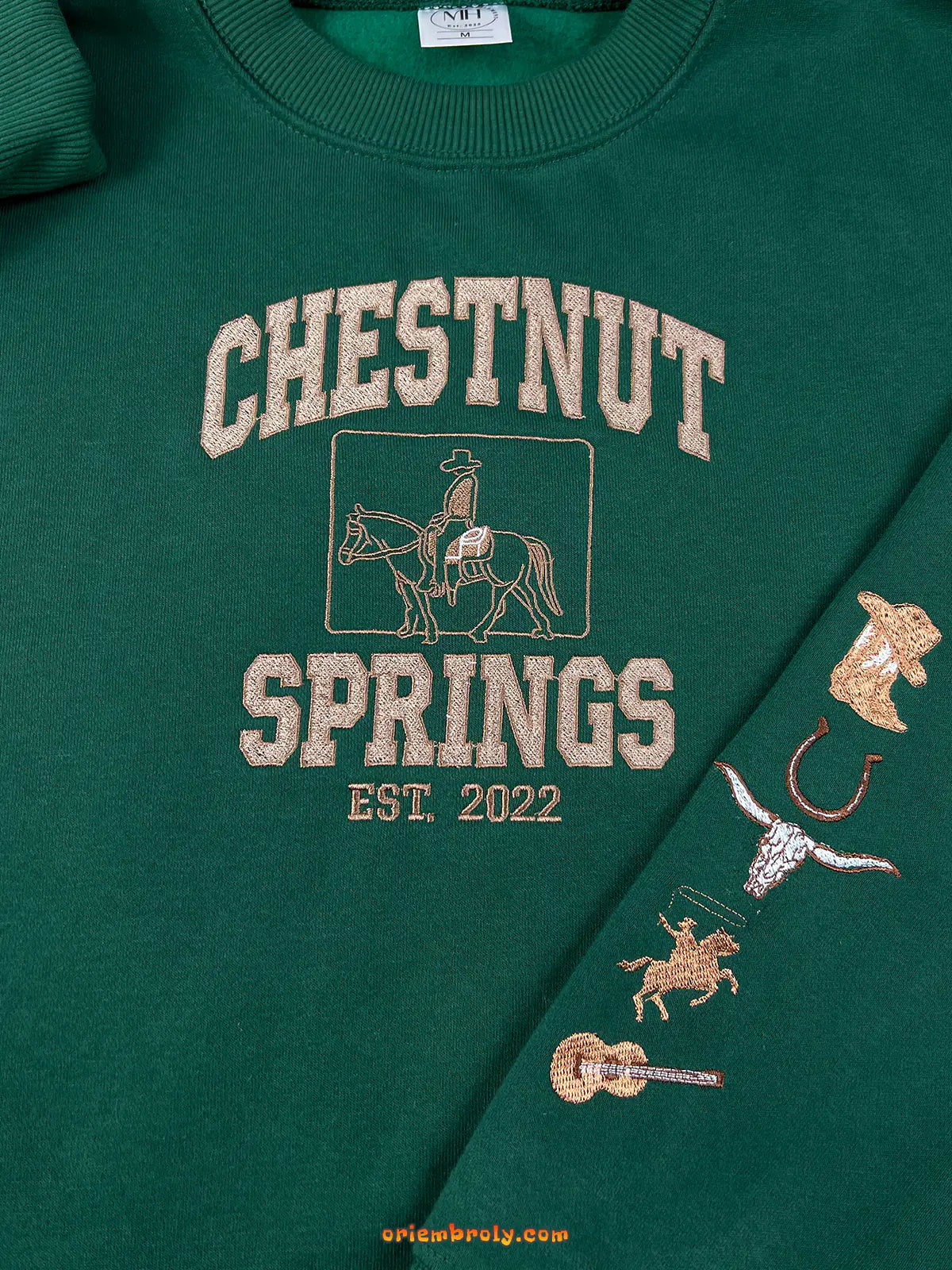 Green sweatshirt with 'Chestnut Springs' text and horse graphics on a green background