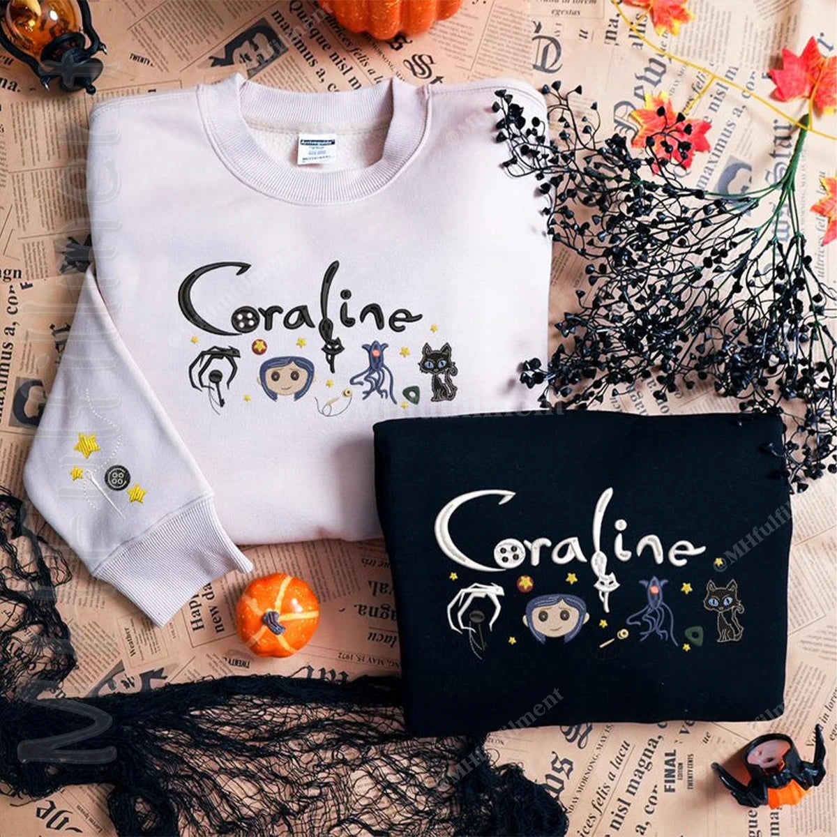 White and black sweatshirts with 'Coraline' design on a newspaper background