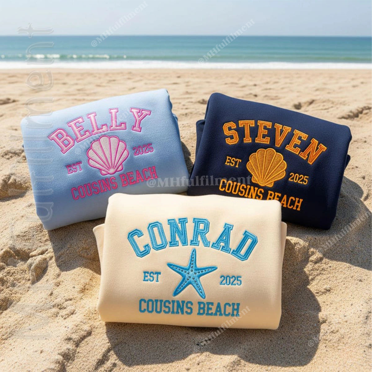 Three beach towels with personalized names and dates on a sandy beach.
