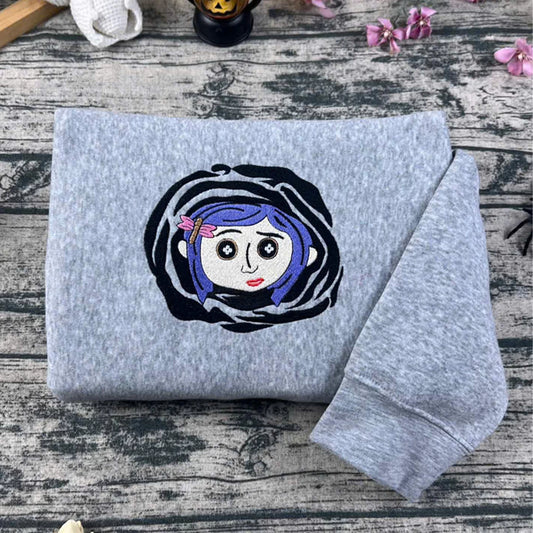 Gray sweatshirt with a cartoon character on a wooden surface