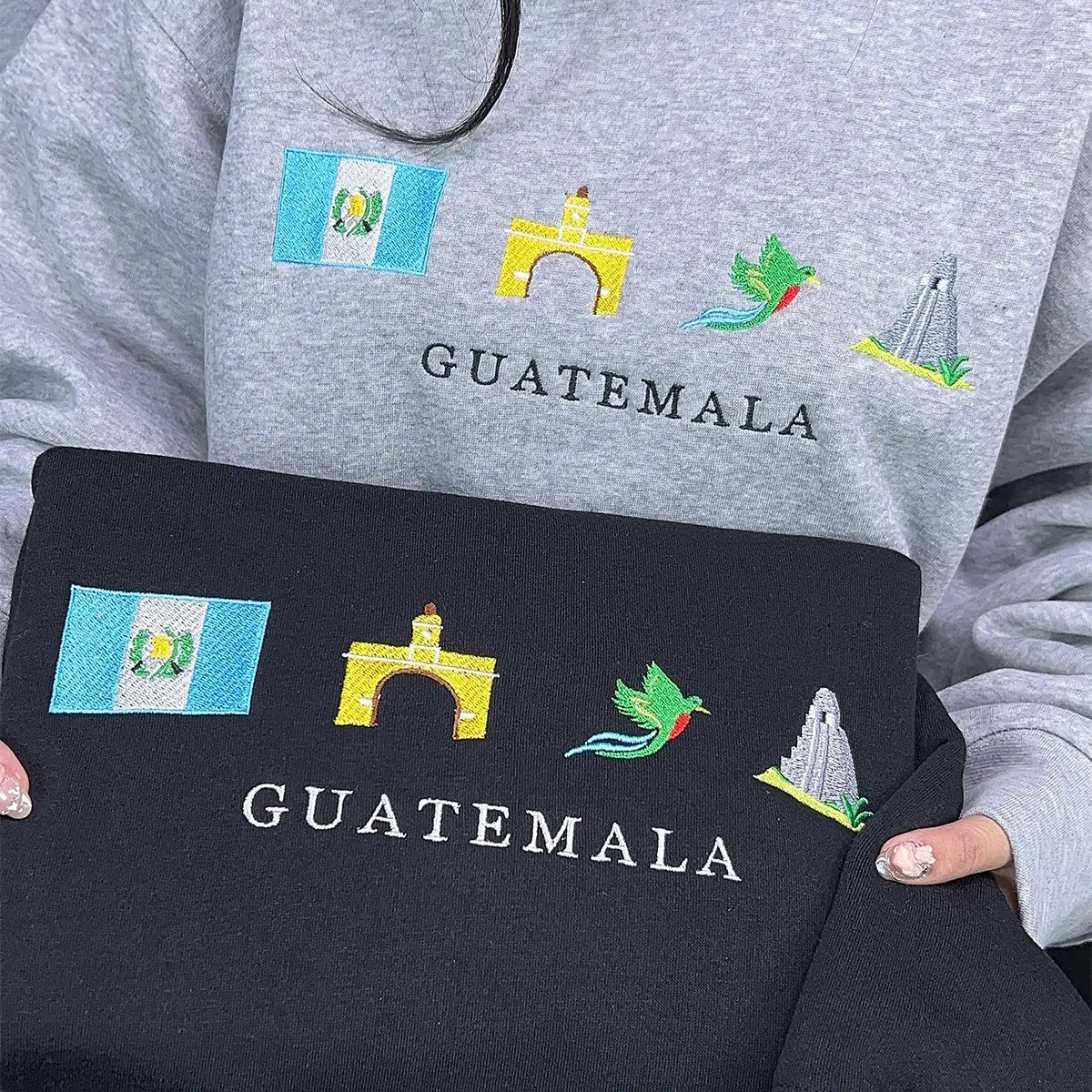Gray sweatshirt and black bag with embroidered Guatemala designs.