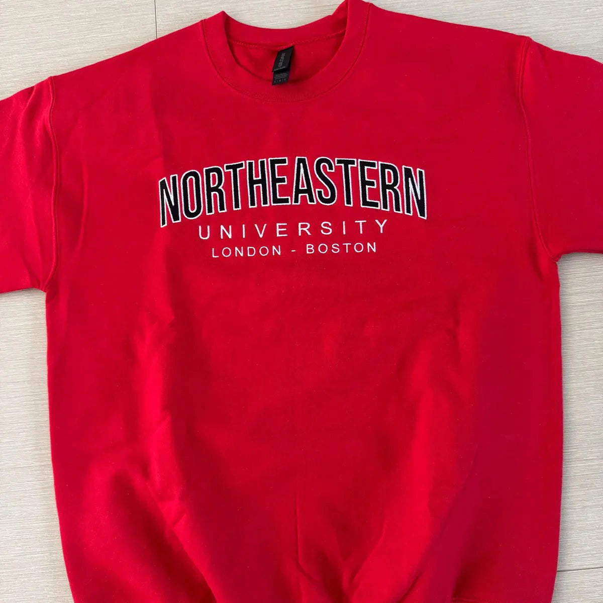 High-quality filled embroidery on varsity crewneck sweatshirt
