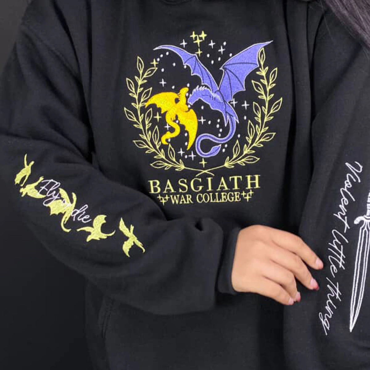 Black hoodie with dragon design and text on a dark background