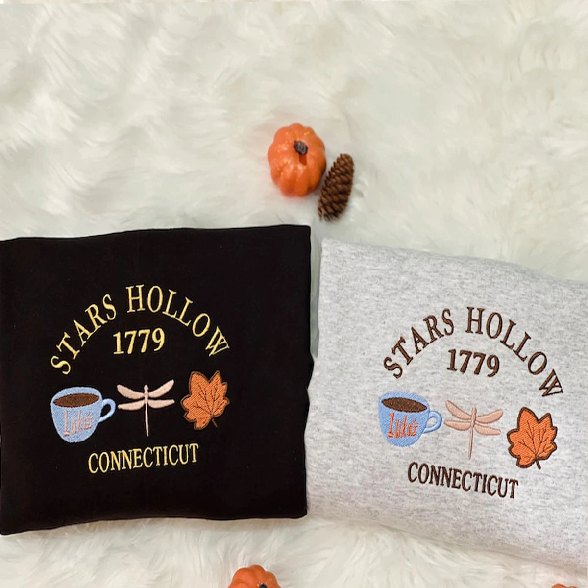 Two pillows with 'Stars Hollow 1779 Connecticut' design on a white surface.
