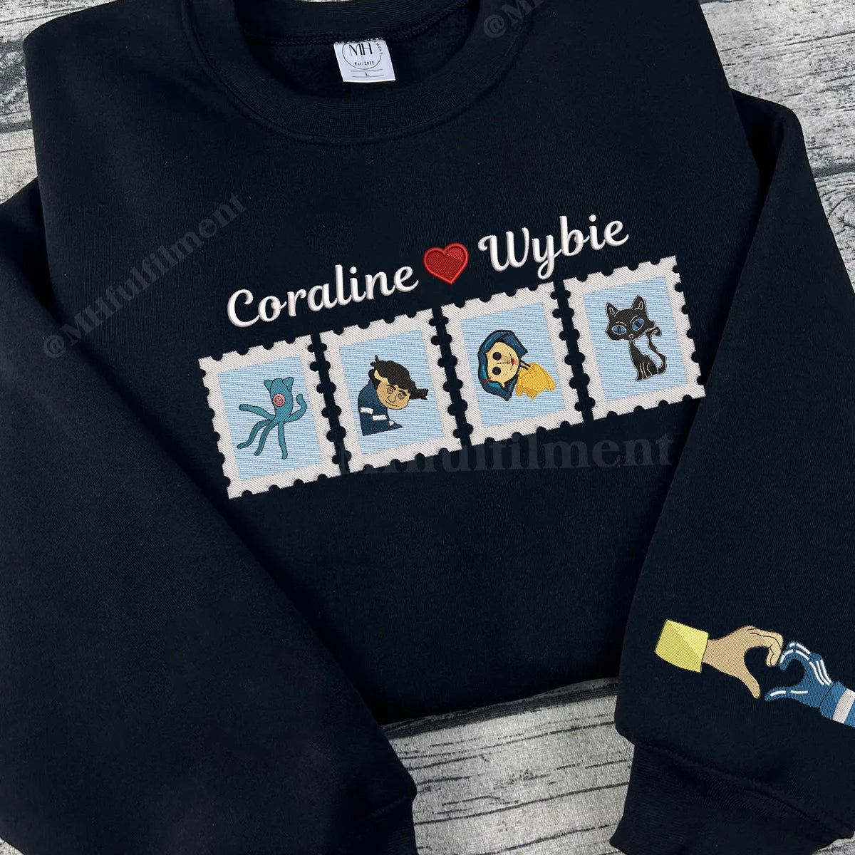 Black sweatshirt with 'Coraline loves Wybie' design featuring characters and a heart on a textured surface.