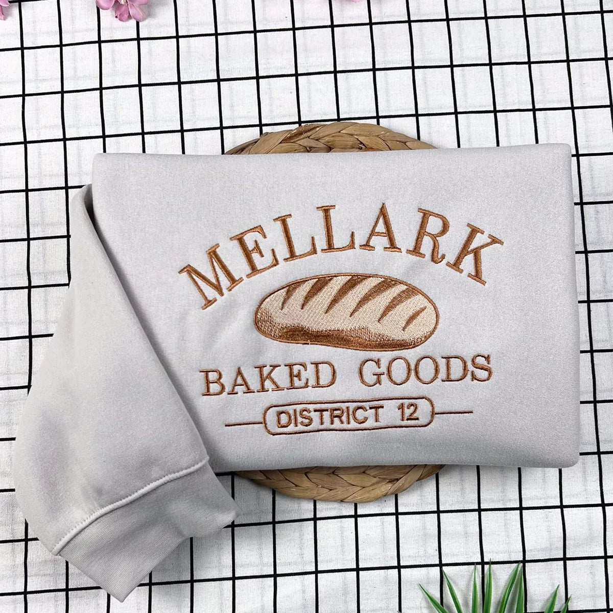Hunger Games inspired embroidered Mellark sweatshirt, Abanathy Liquors shirt design, ideal bookish fan gift.