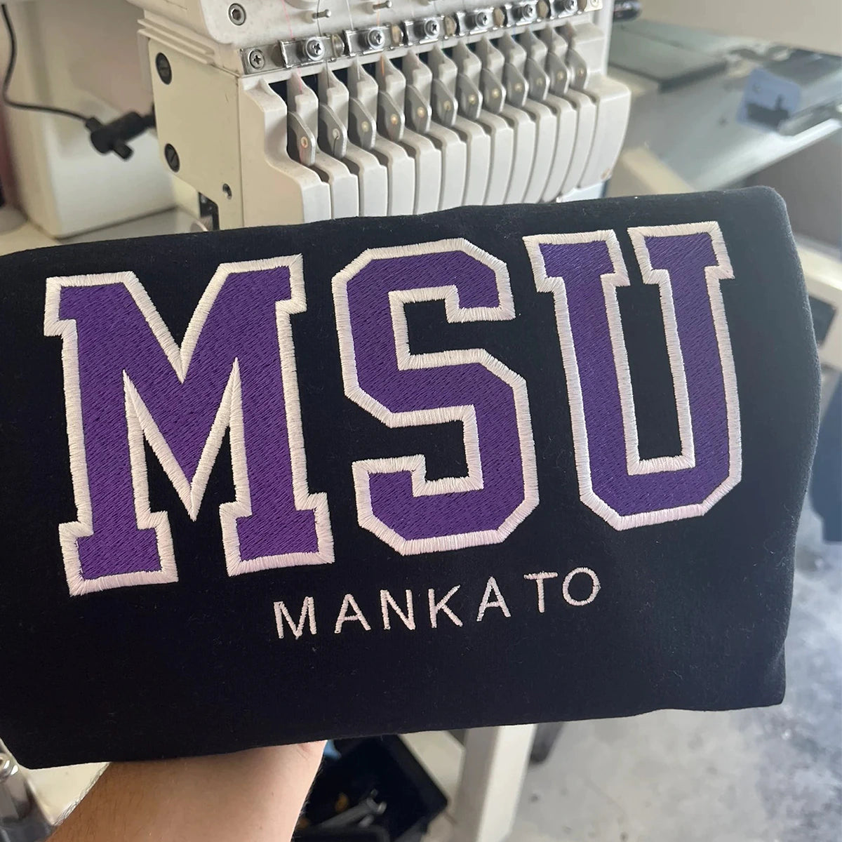 Close-up of embroidered MSU on crewneck sweatshirt