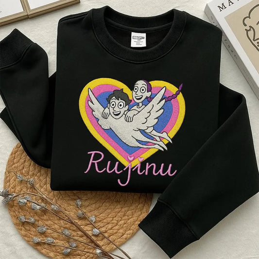 Black sweatshirt with a colorful graphic and 'Rujinu' text on a light surface.