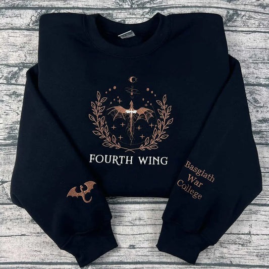 Black hoodie with 'Fourth Wing' and 'Basgalth War College' text on a wooden surface