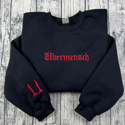 Black sweatshirt with red text and logo on a wooden surface