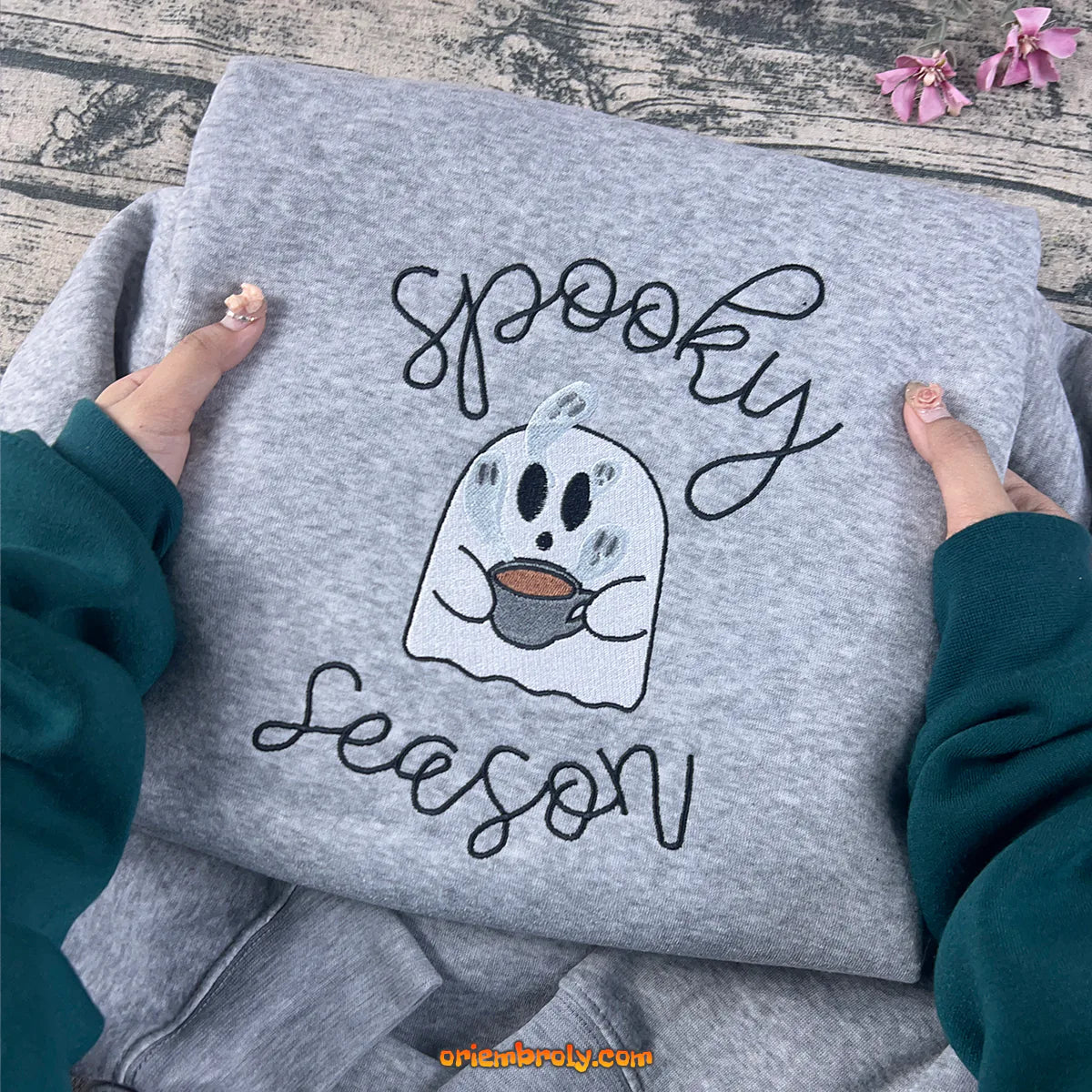 Close-up embroidery of ghost on grey Halloween sweatshirt