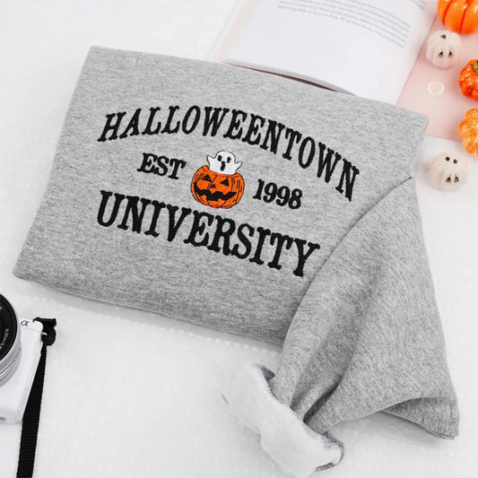 Gray sweatshirt with 'Halloweentown University Est. 1998' text and pumpkin graphic on a white background.