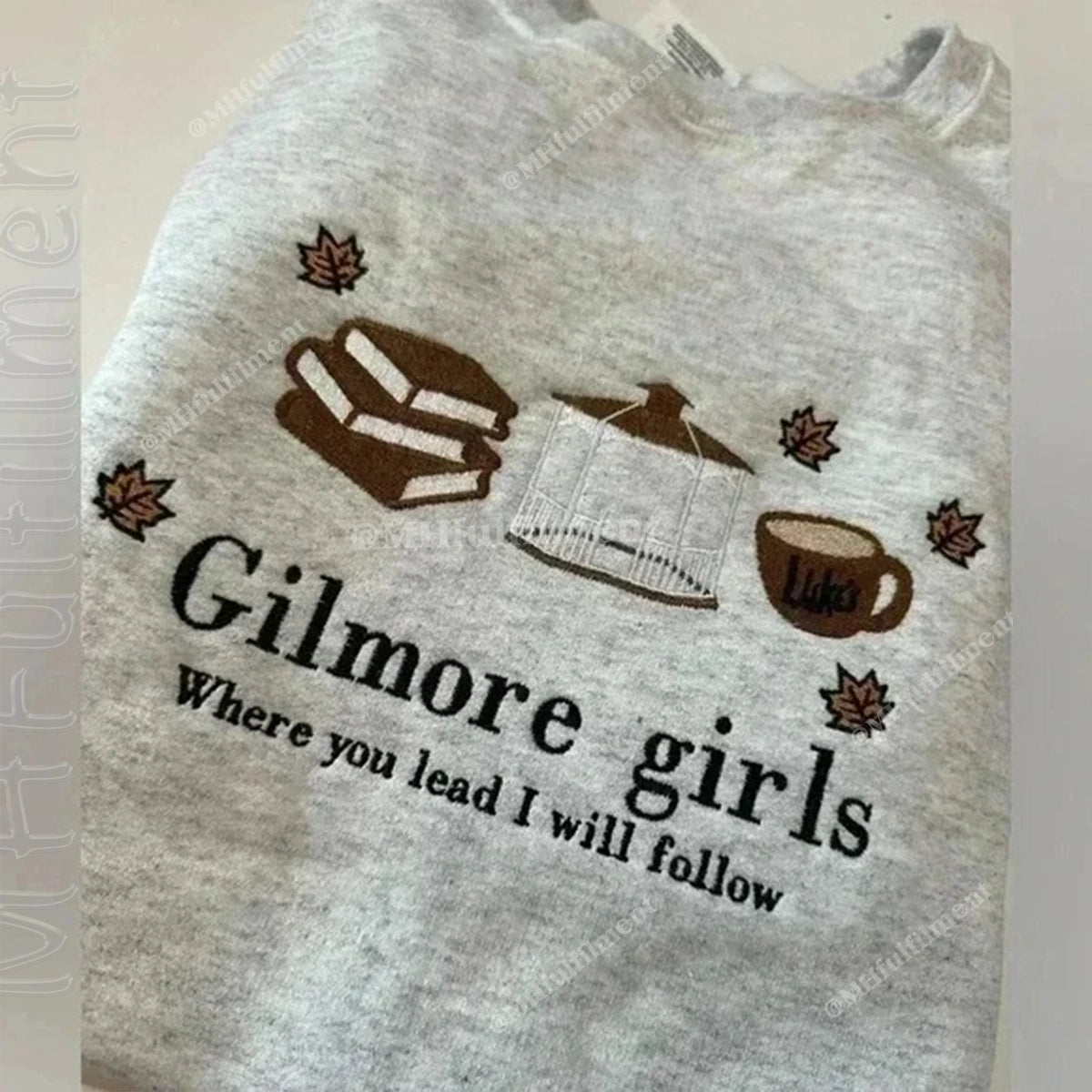 Gray tank top with 'Gilmore girls Where you lead I will follow' text and graphics on a plain background