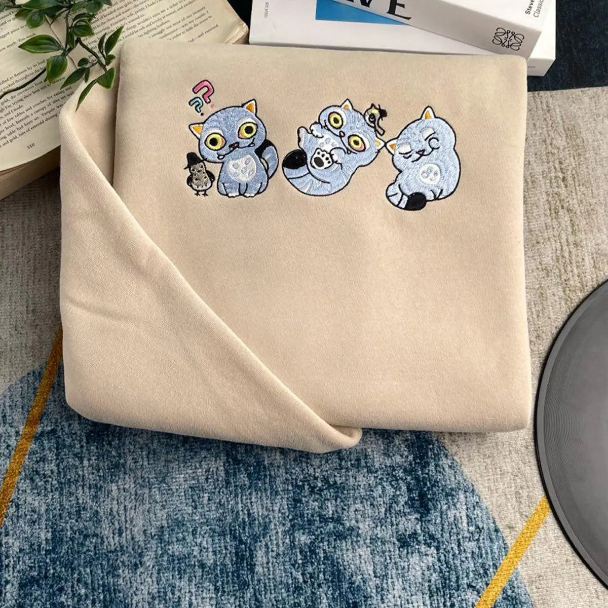 Beige fabric with cartoon cat designs on a textured surface