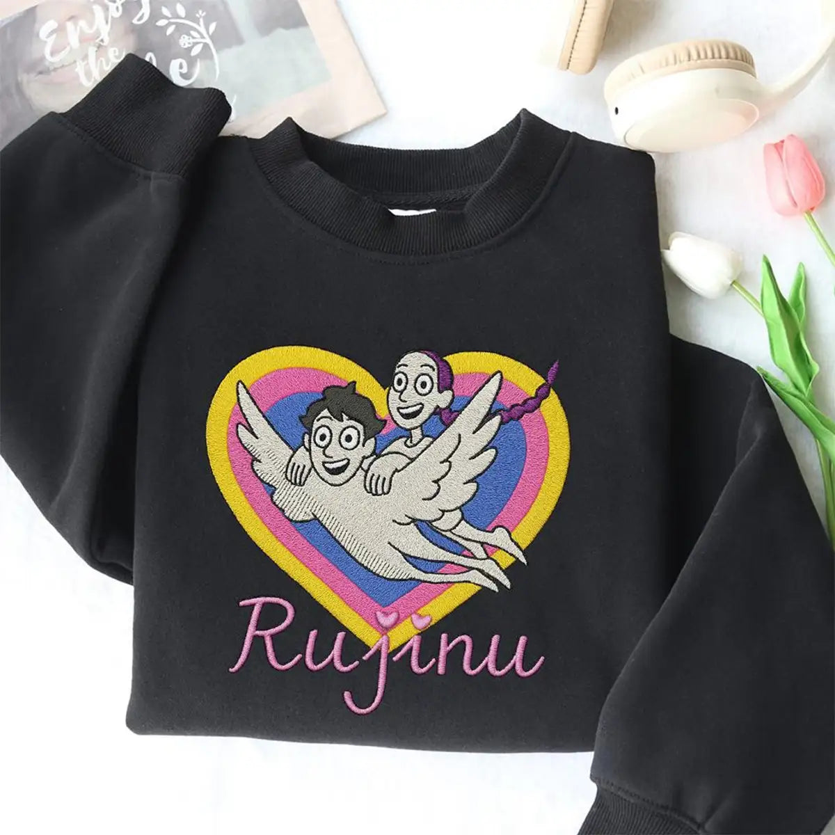 Black sweatshirt with a colorful graphic and 'Rujinu' text on a white background