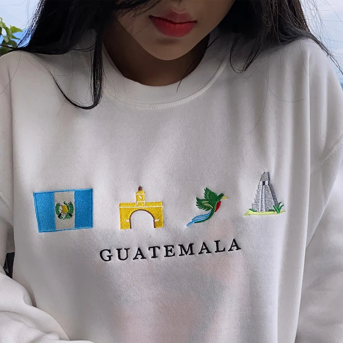 White sweatshirt with embroidered designs and 'Guatemala' text