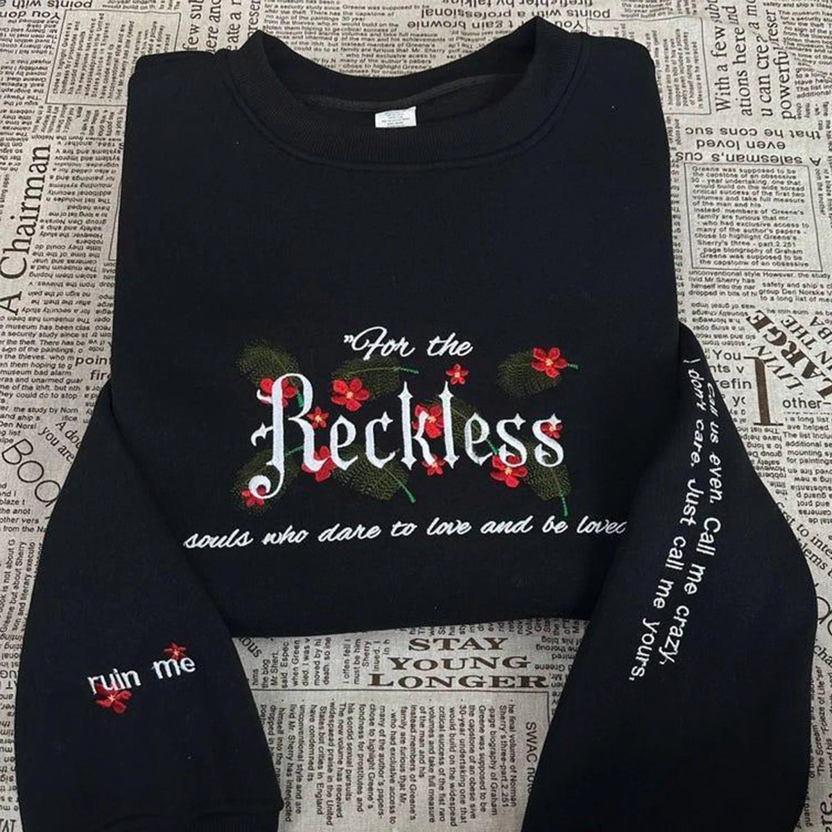 Reckless embroidered sweatshirt featuring Kai and Paedyn from Lauren Roberts Merch, a powerful book shirt for fantasy lovers.