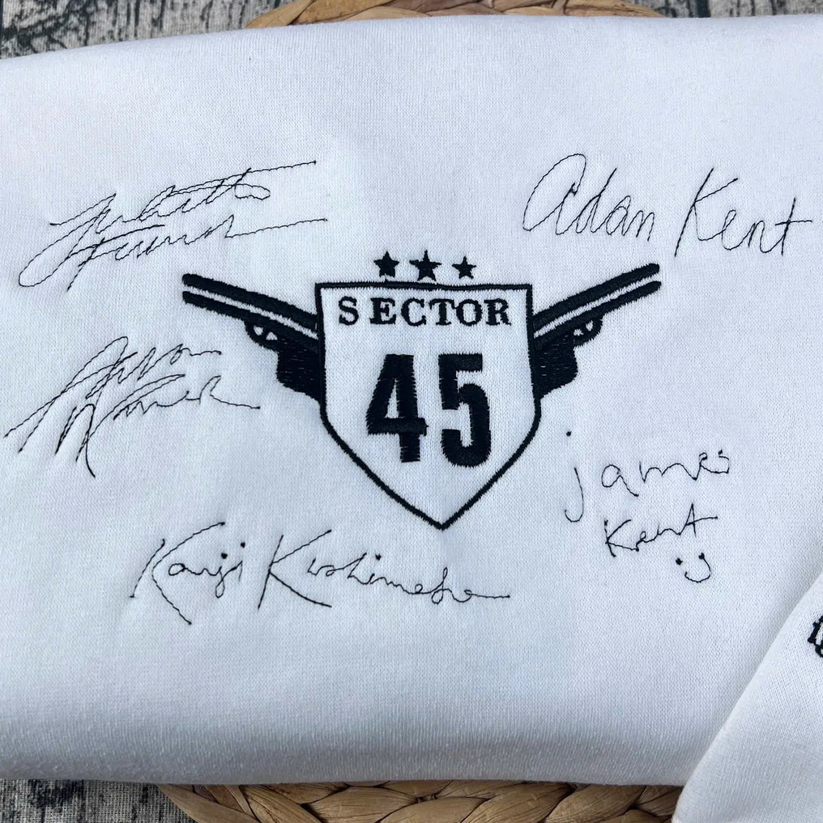 Aaron Warner Sector 45 embroidered sweatshirt from Shatter Me series, cozy bookish apparel for readers.