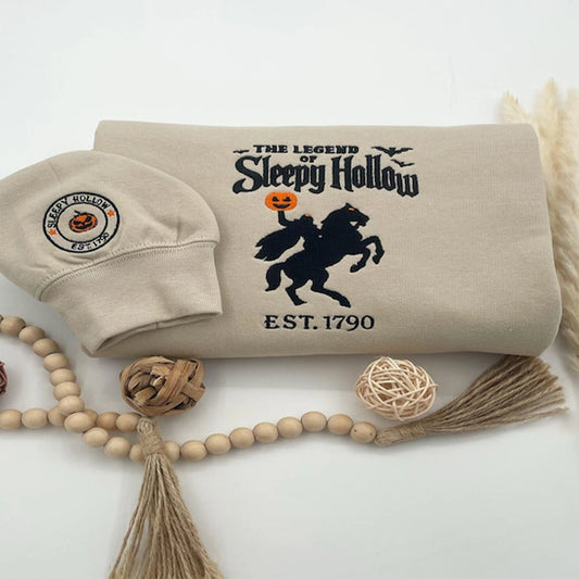 Beige pillow with 'The Legend of Sleepy Hollow' design, matching headband, and decorative elements on a white background.