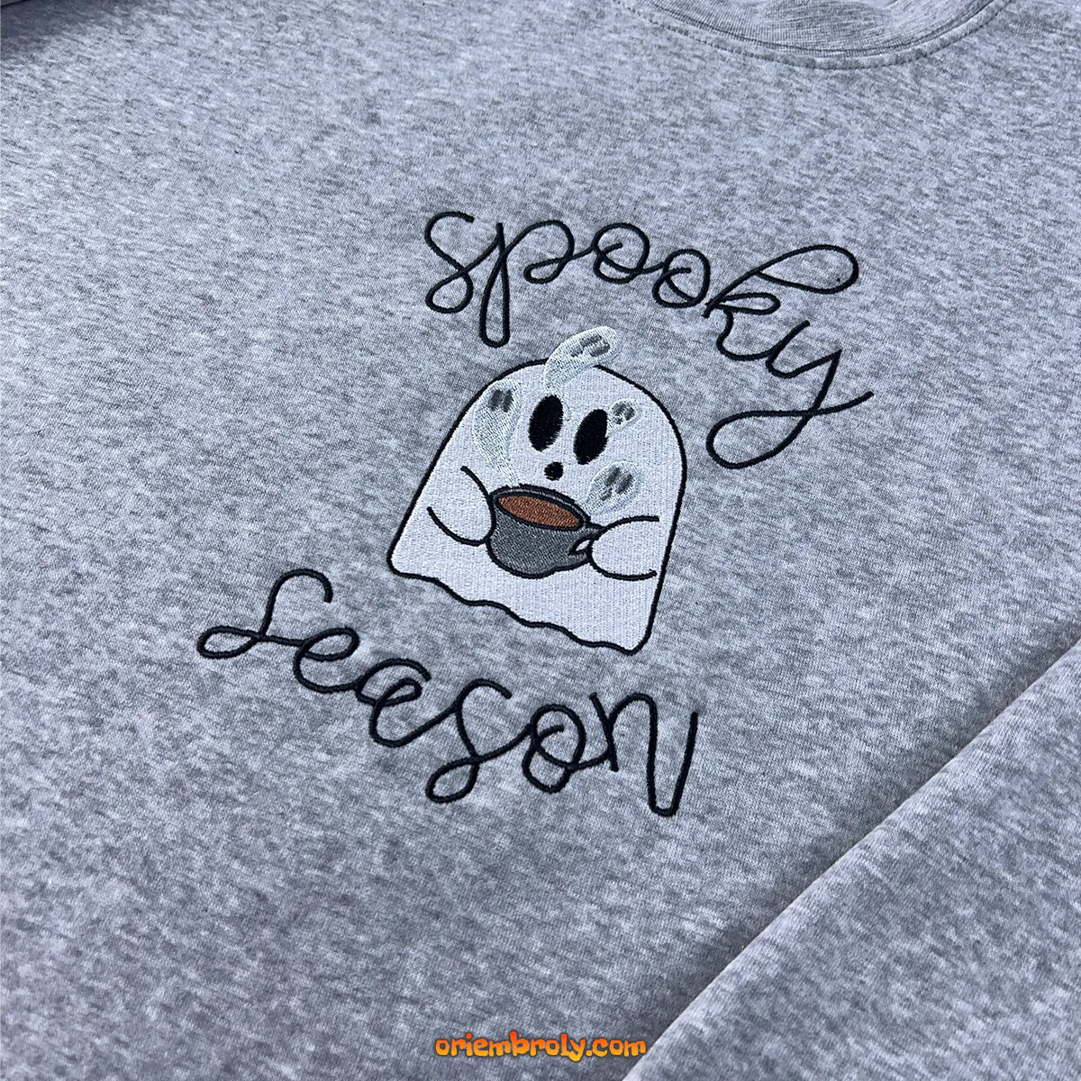 Halloween flatlay of spooky embroidered hoodie with fall decor