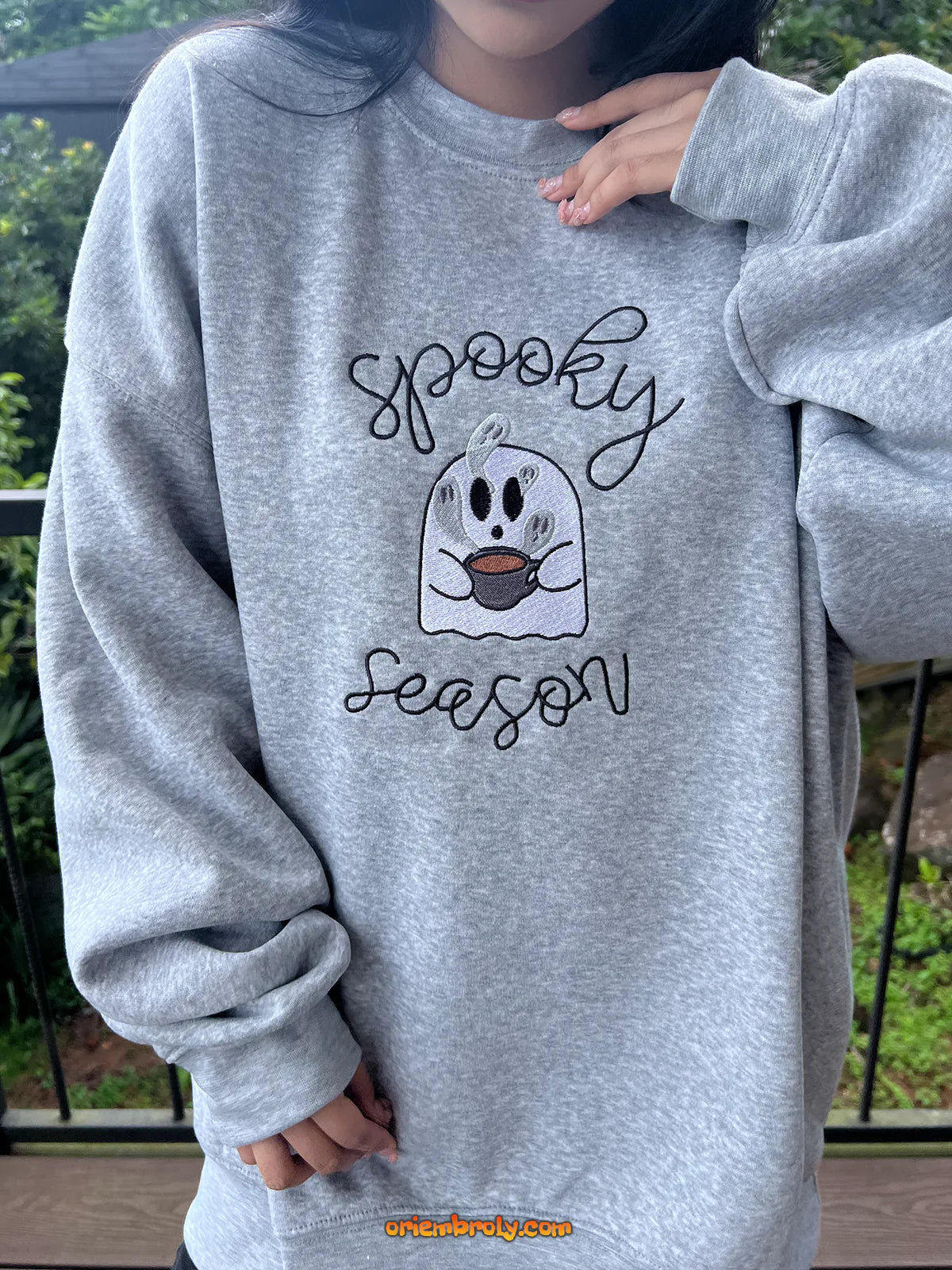 Cozy fall outfit with spooky season sweatshirt worn by model