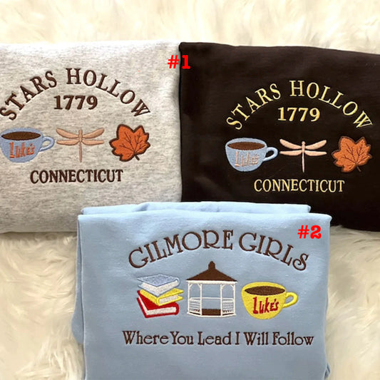 Three pillows with 'Stars Hollow 1779 Connecticut' and 'Gilmore Girls' designs on a textured surface.