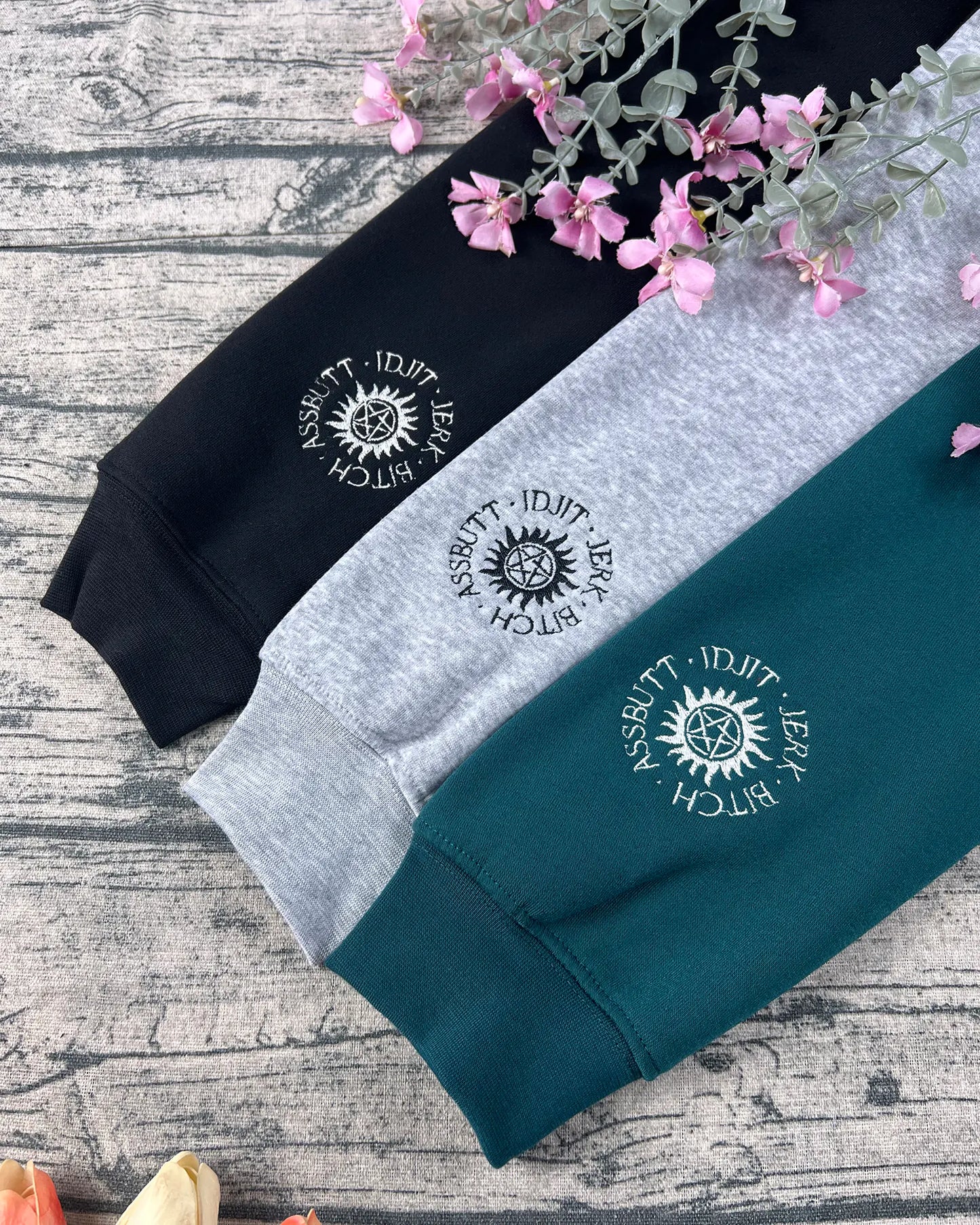 Supernatural embroidered sweatshirt featuring Dean, Sam, and Castiel design.