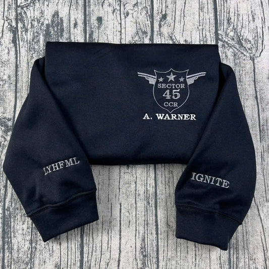 The Shatter Me crewneck sweatshirt, custom embroidered Kishimoto Sector 45 uniform design, featuring A Warner. Perfect for book lovers and fans of Hell Is Empty shirt