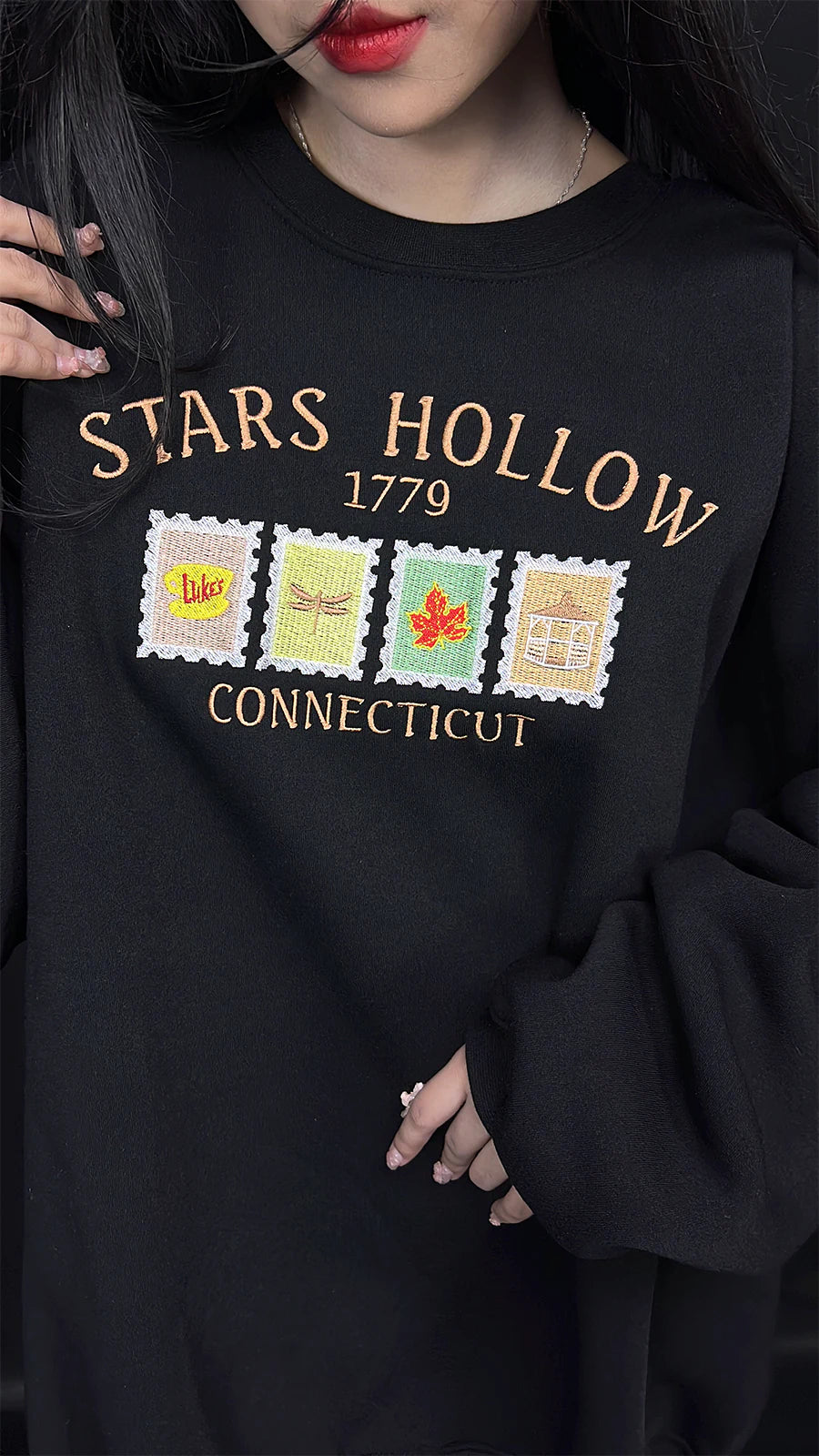 Black sweatshirt with 'Stars Hollow 1779 Connecticut' design on a plain background