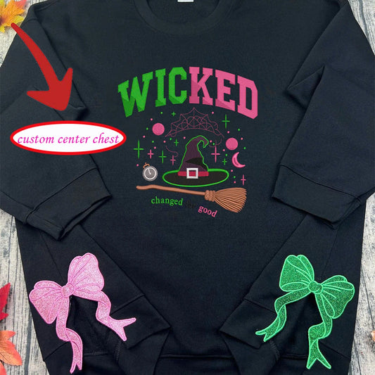 Black sweatshirt with 'Wicked' design and colorful graphics on a wooden surface.