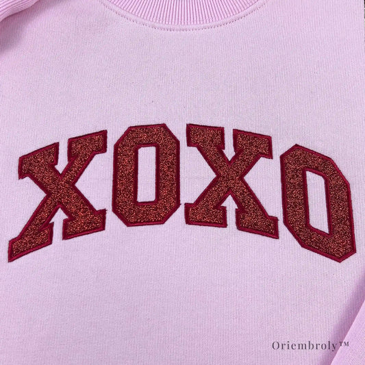 Varsity-style XOXO embroidery with subtle glitter texture