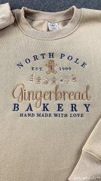 North Pole Gingerbread Bakery Holiday Embroidered Beige Crewneck Sweatshirt