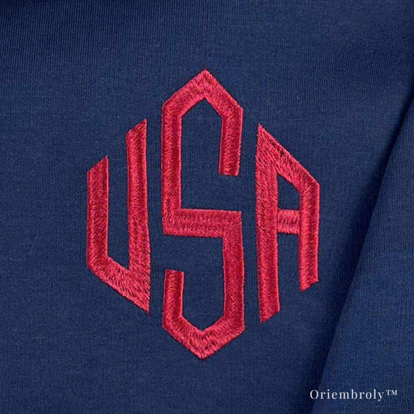 close-up of 3 letter embroidery on quarter zip sweatshirt