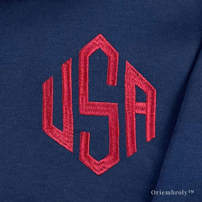 close-up of 3 letter embroidery on quarter zip sweatshirt
