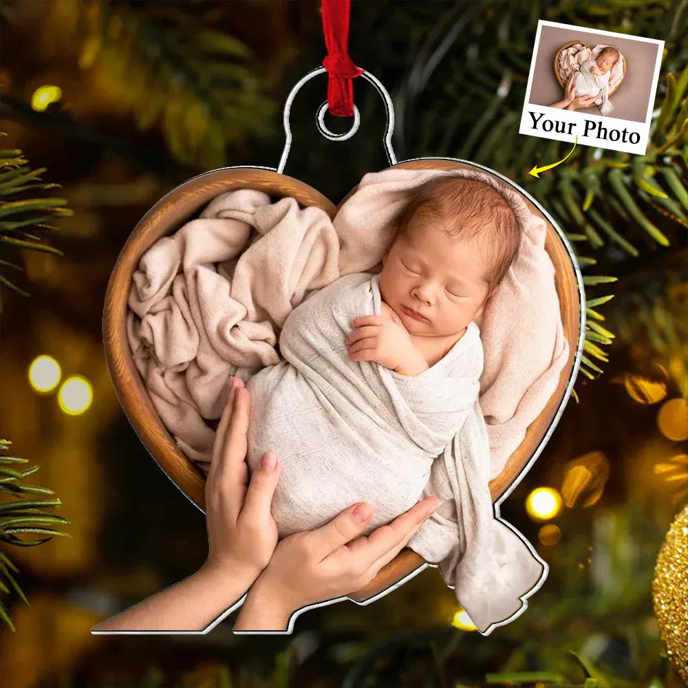 Personalized custom photo acrylic ornament featuring a newborn baby wrapped in a blanket, designed as a Baby's First Christmas keepsake or a gift for new parents.