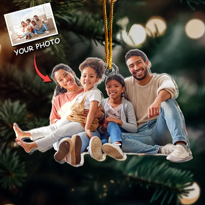 A custom acrylic photo ornament featuring a happy family, hanging on a Christmas tree. This personalized keepsake is a perfect Christmas gift.