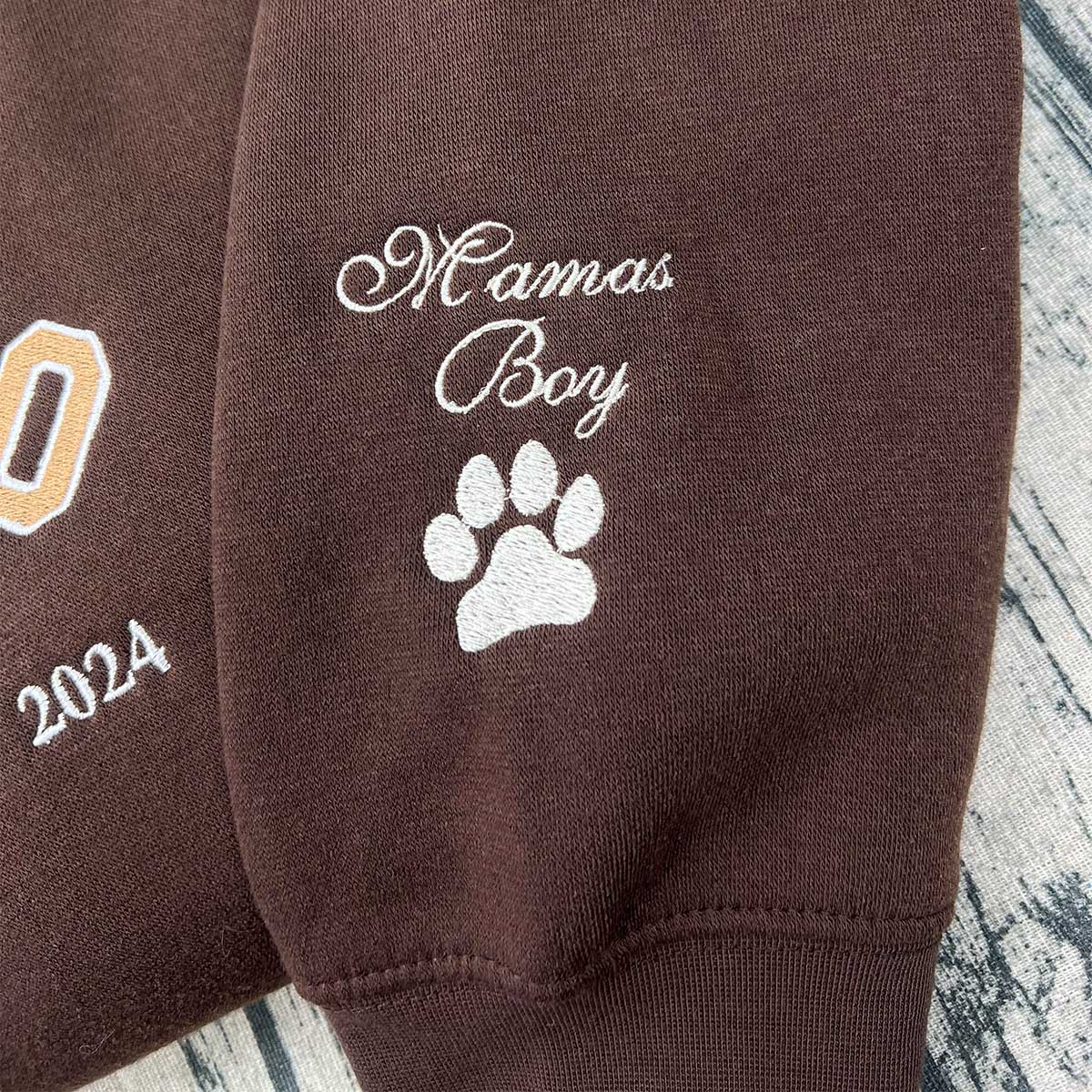 Custom embroidered hoodie featuring a pet’s paw print design.
