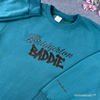 Aesthetic Bridgerton merch: Teal crewneck sweater featuring "Bridgerton Baddie" embroidery