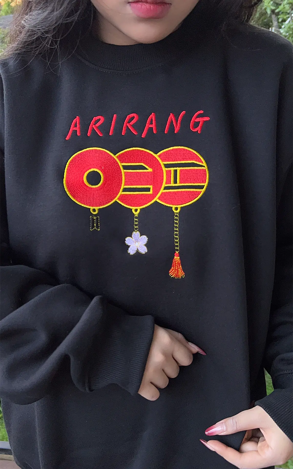 Aesthetic K-pop style black sweater featuring minimalist BTS red circle embroidery