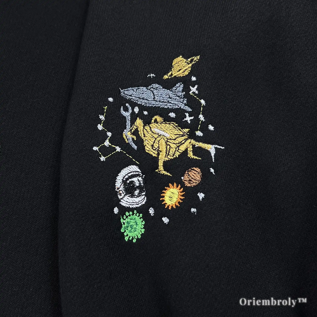 "Amaze Amaze Amaze" yellow embroidered quarter-zip with Rocky the Eridian and astronaut icons. Unique bookish streetwear inspired by the scientific friendship in Project Hail Mary