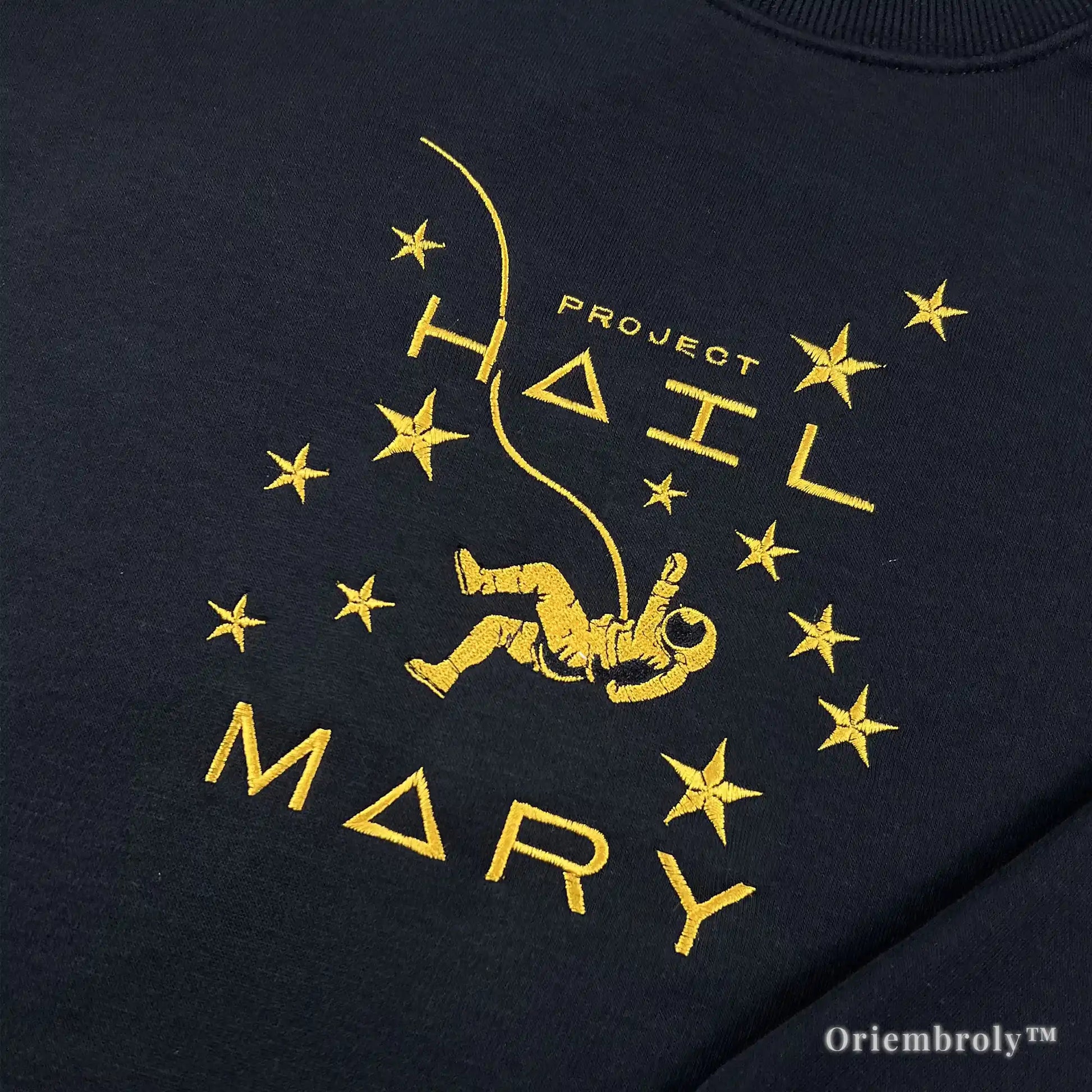 Officially inspired Project Hail Mary merch: a premium black pullover with high-density yellow satin stitch embroidery of a floating astronaut and stars. A must-have for Andy Weir fans