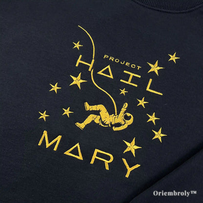 Officially inspired Project Hail Mary merch: a premium black pullover with high-density yellow satin stitch embroidery of a floating astronaut and stars. A must-have for Andy Weir fans