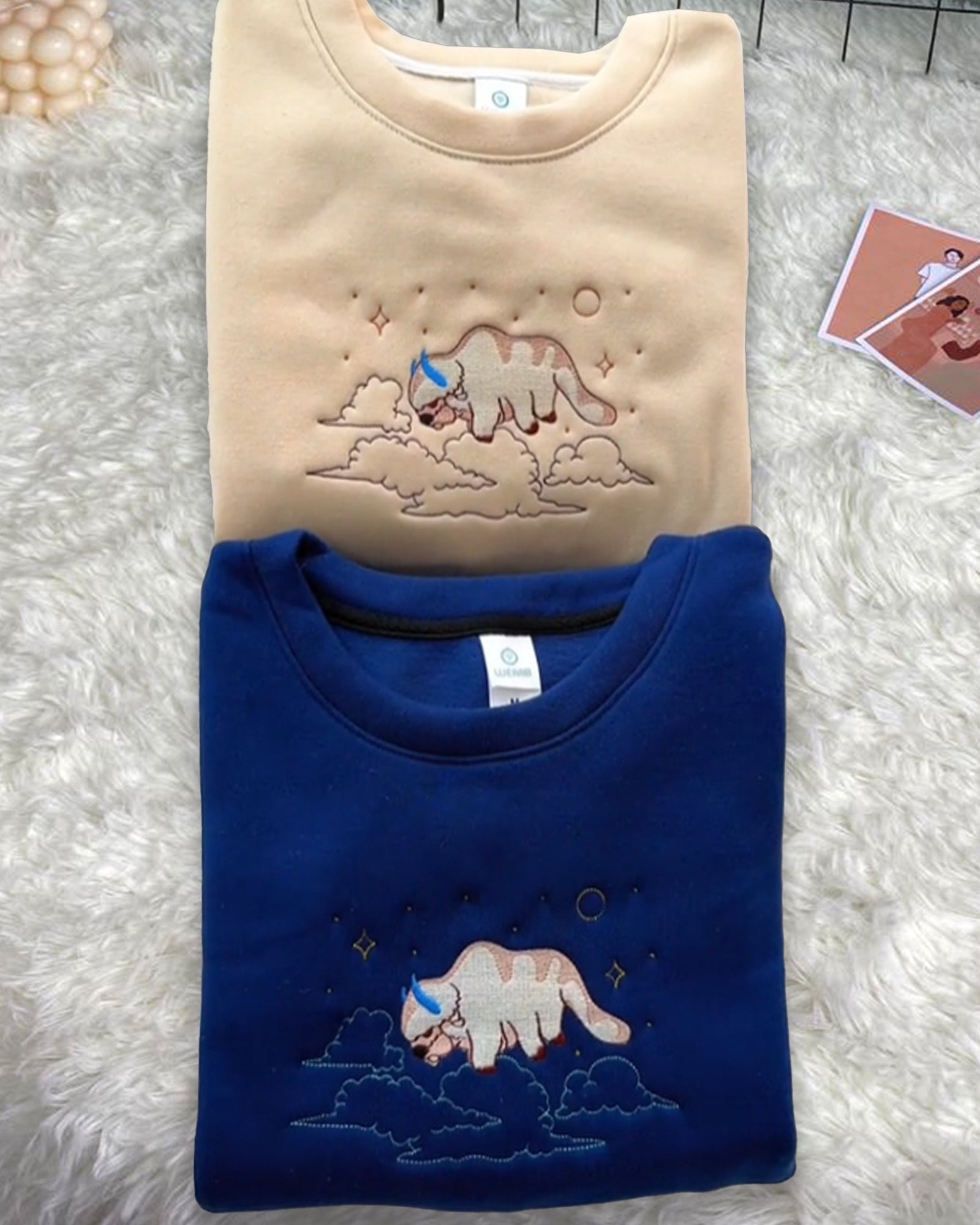 Appa sky bison flying through clouds and stars anime embroidered vintage crewneck sweatshirt in beige and royal blue