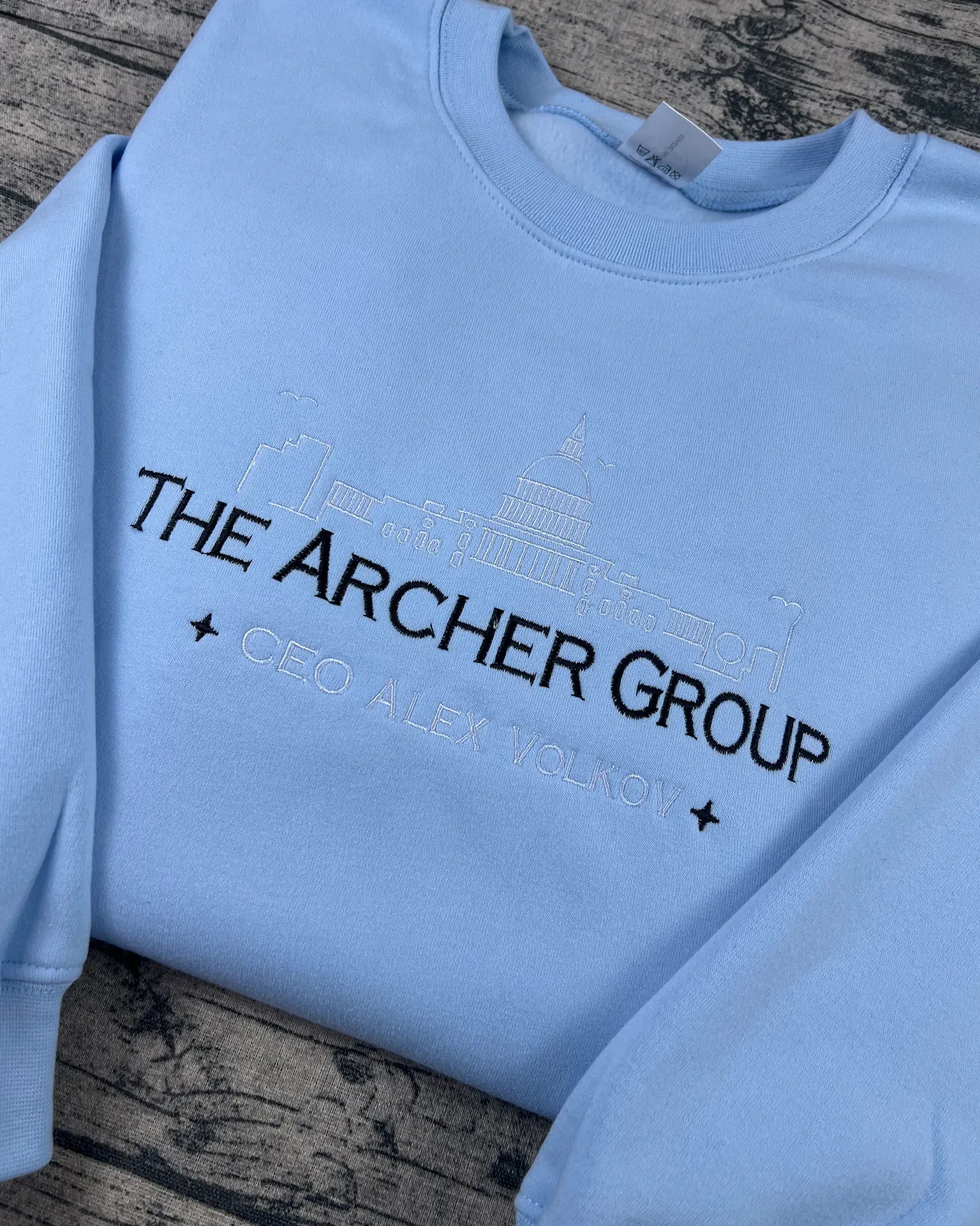 Dark blue skyline embroidery on romance novel fan sweatshirt