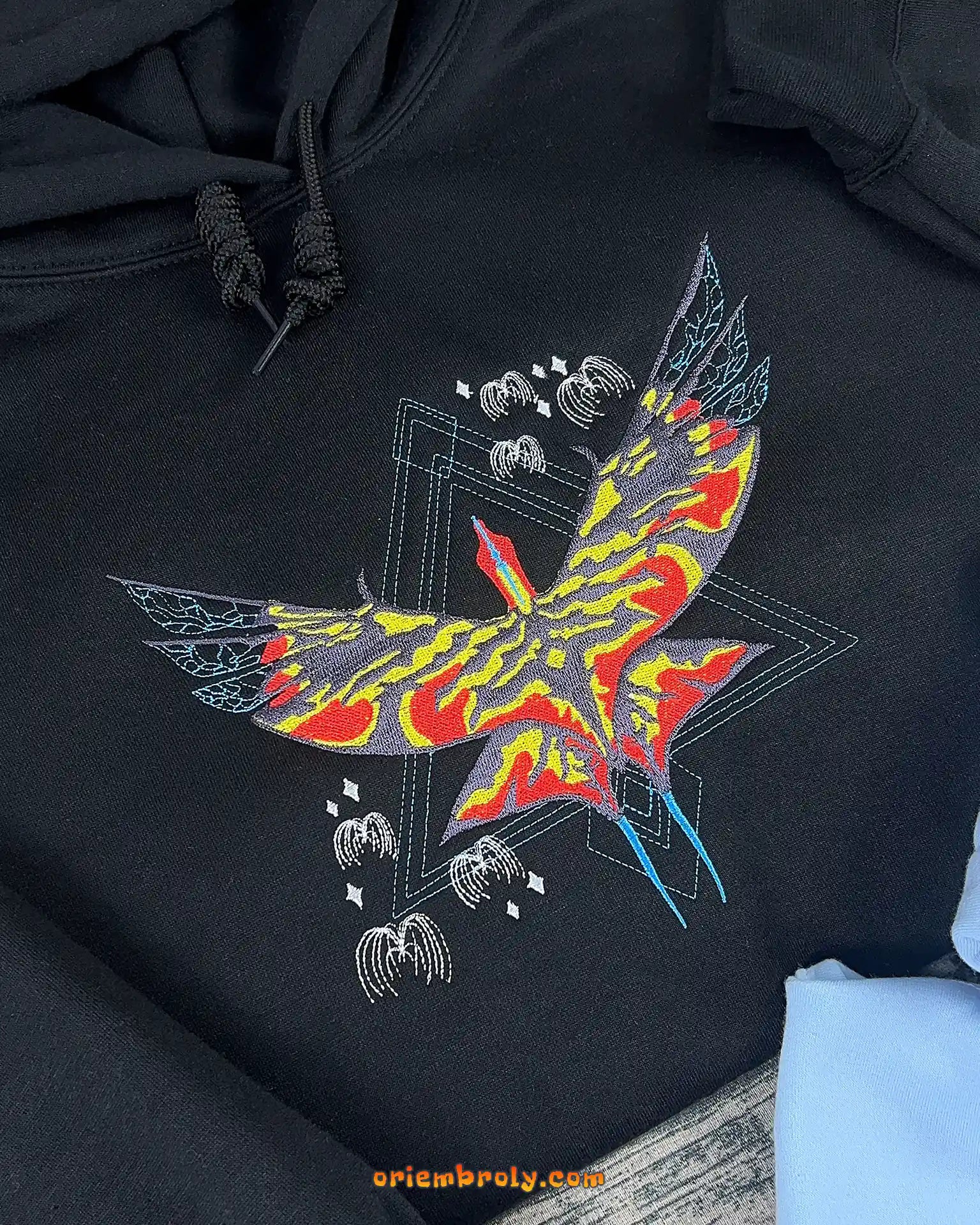 Phoenix-inspired elemental embroidery detail on hoodie