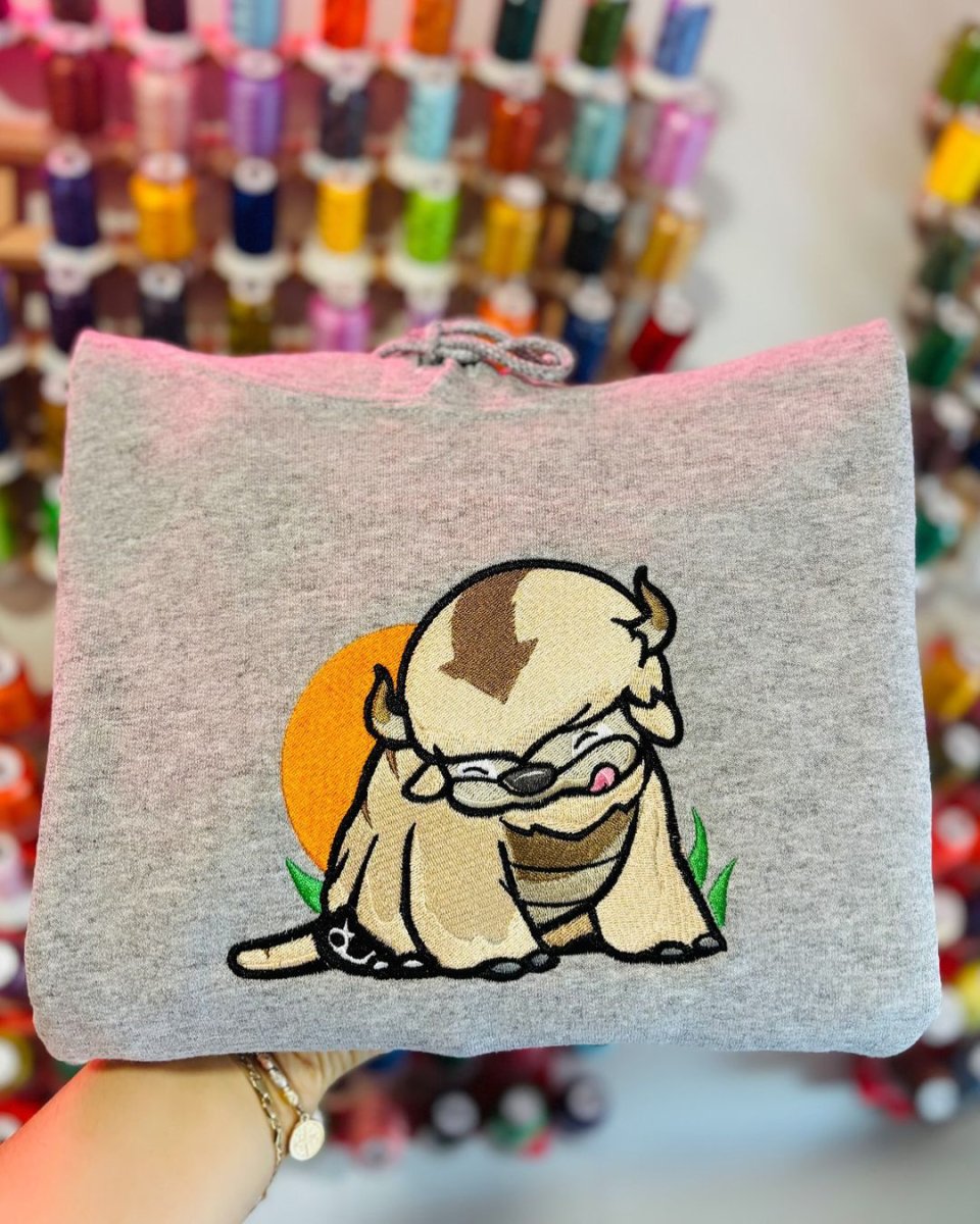 Baby Appa sky bison sitting happy anime embroidered vintage hoodie in heather grey