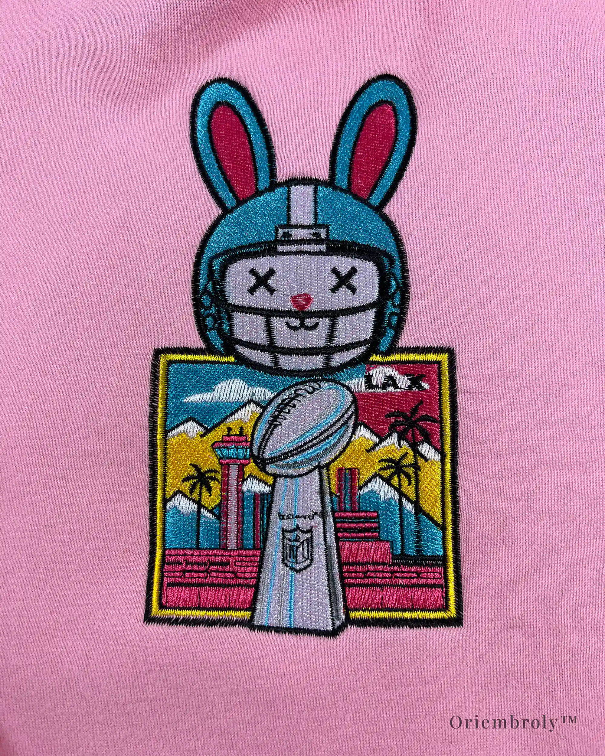 Pink hoodie with Bad Bunny-inspired embroidery detail