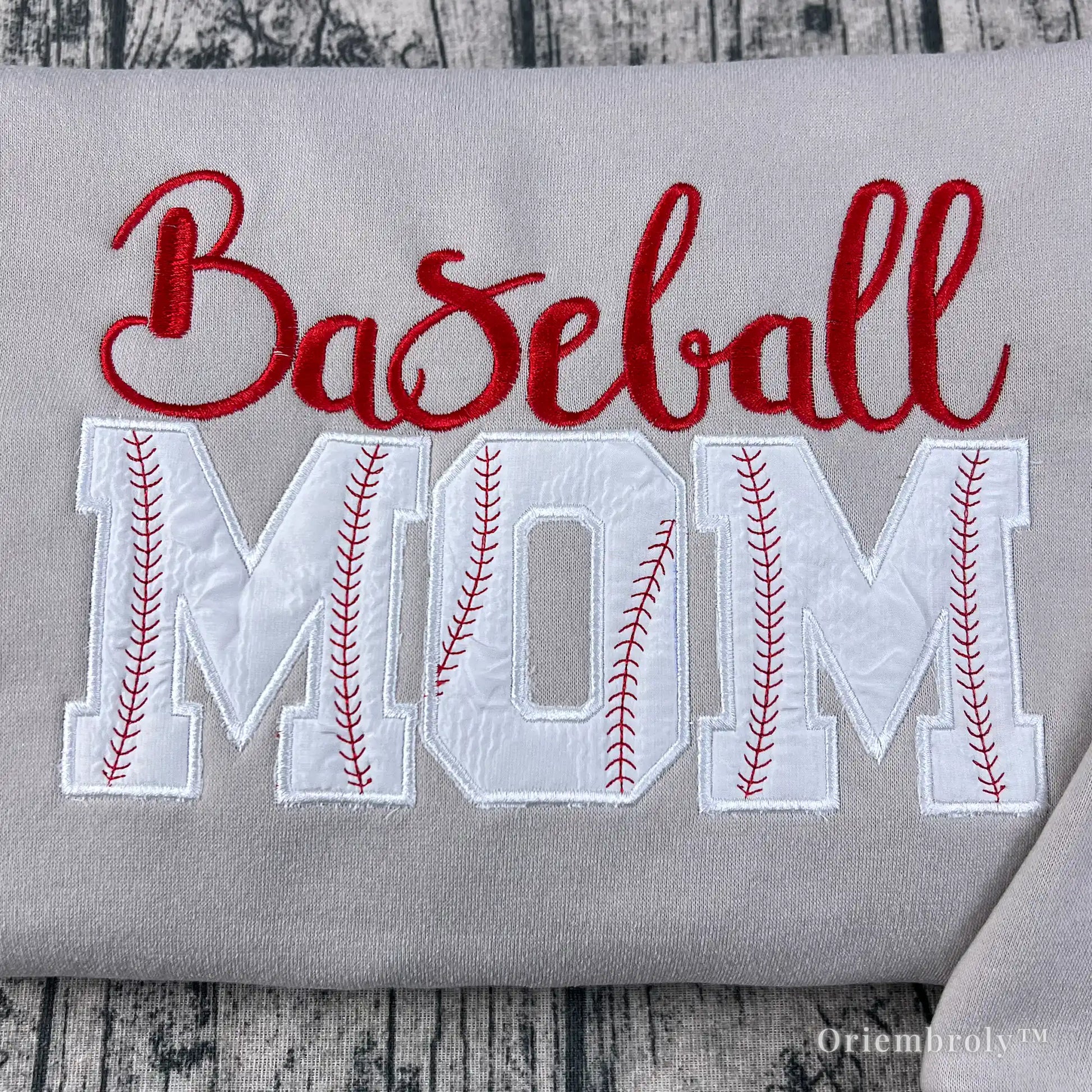 close up applique MOM lettering with red baseball stitching