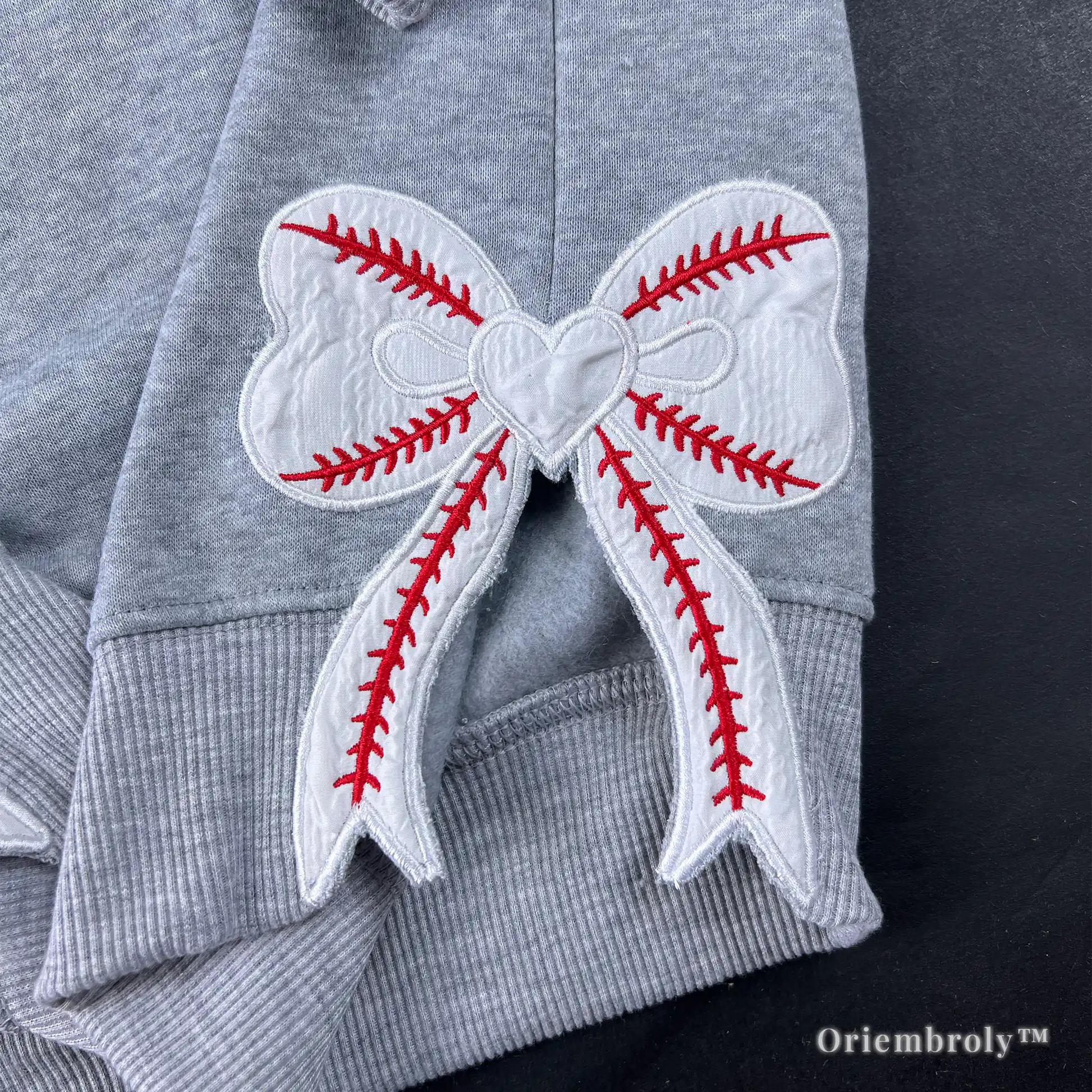 embroidered baseball stitch bow detail on sweatshirt hem
